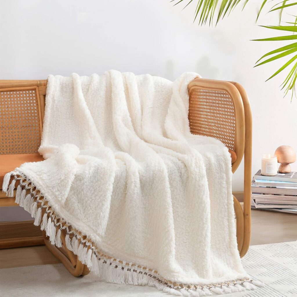 white blanket with tassles