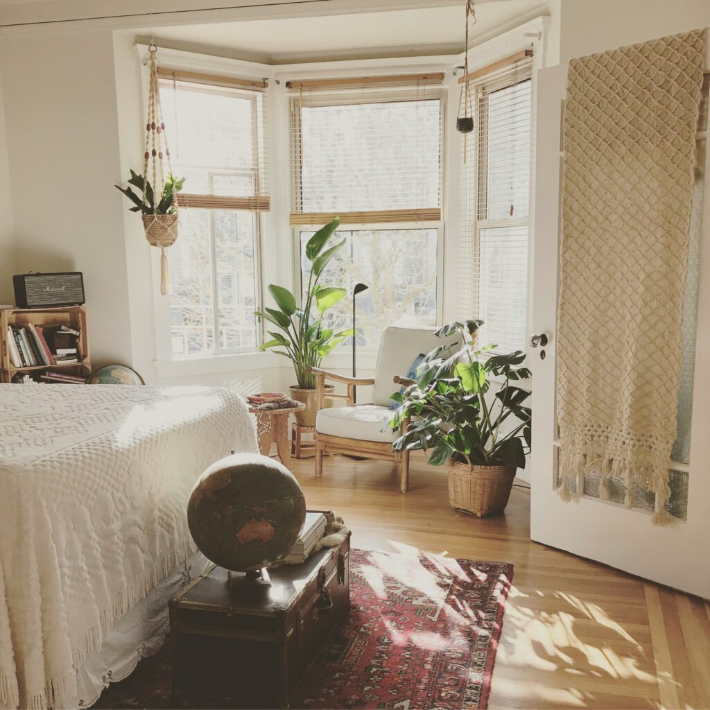 light cored bedroom with windows and plants