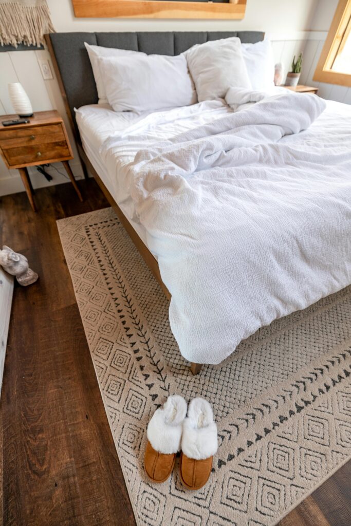 white bedding with area rug