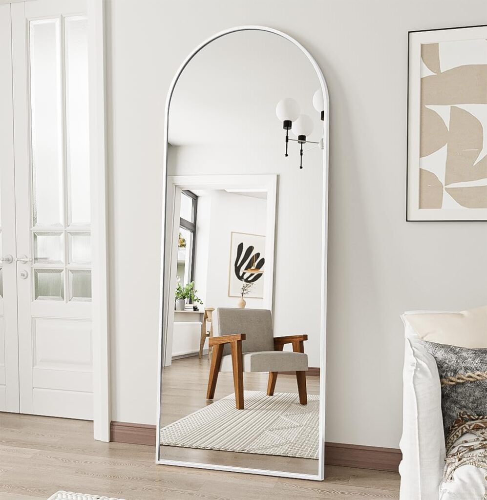white body mirror leaned against a wall