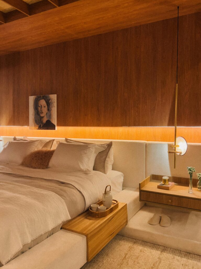 Warm tone bedroom with relaxing light next to bed