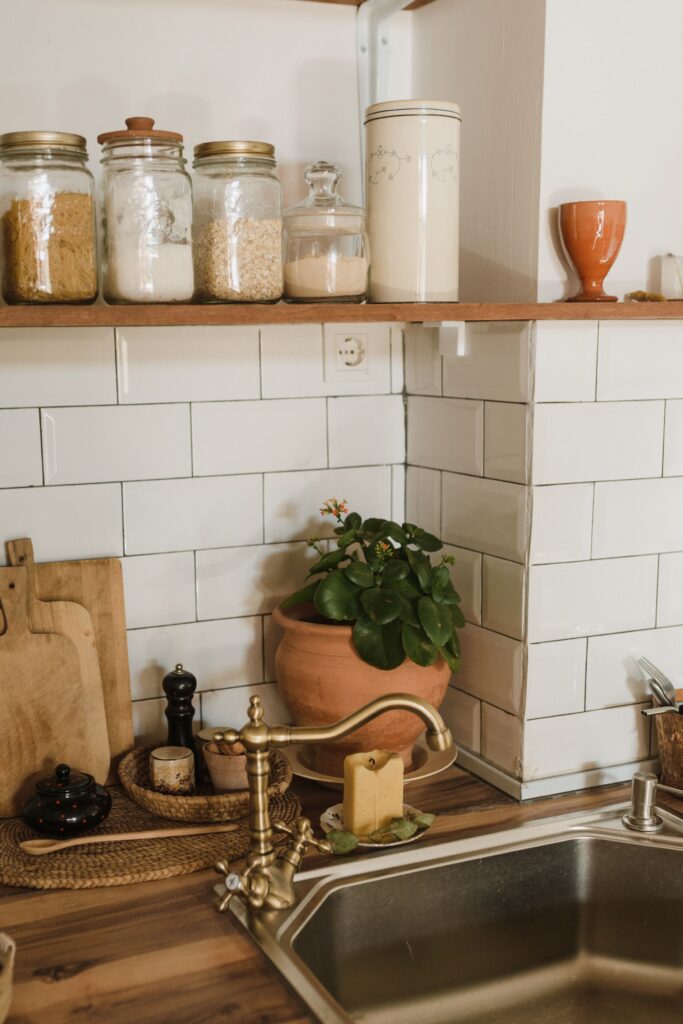 vintage kitchen decor and sink faucet, shelves holding old canisters