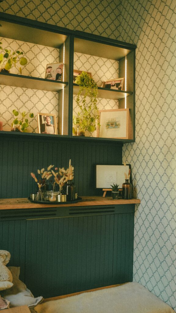deep green shelves in kitchen with geometric wallpaper design
