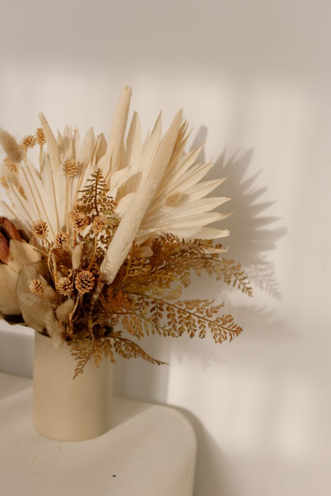 dried floral in a white vase