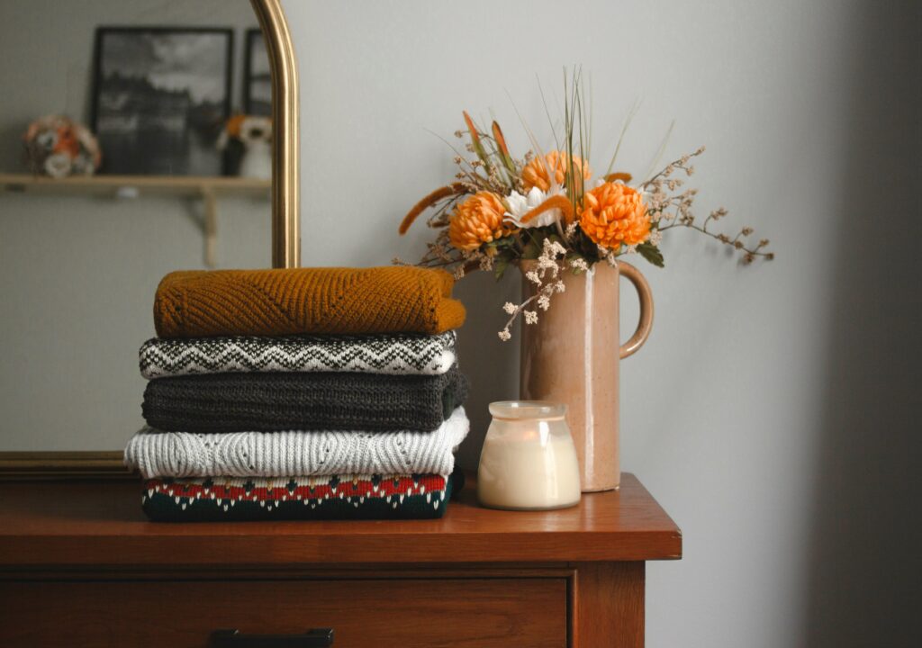 fall bedroom decor with fall colors on a dresser and orange flowers