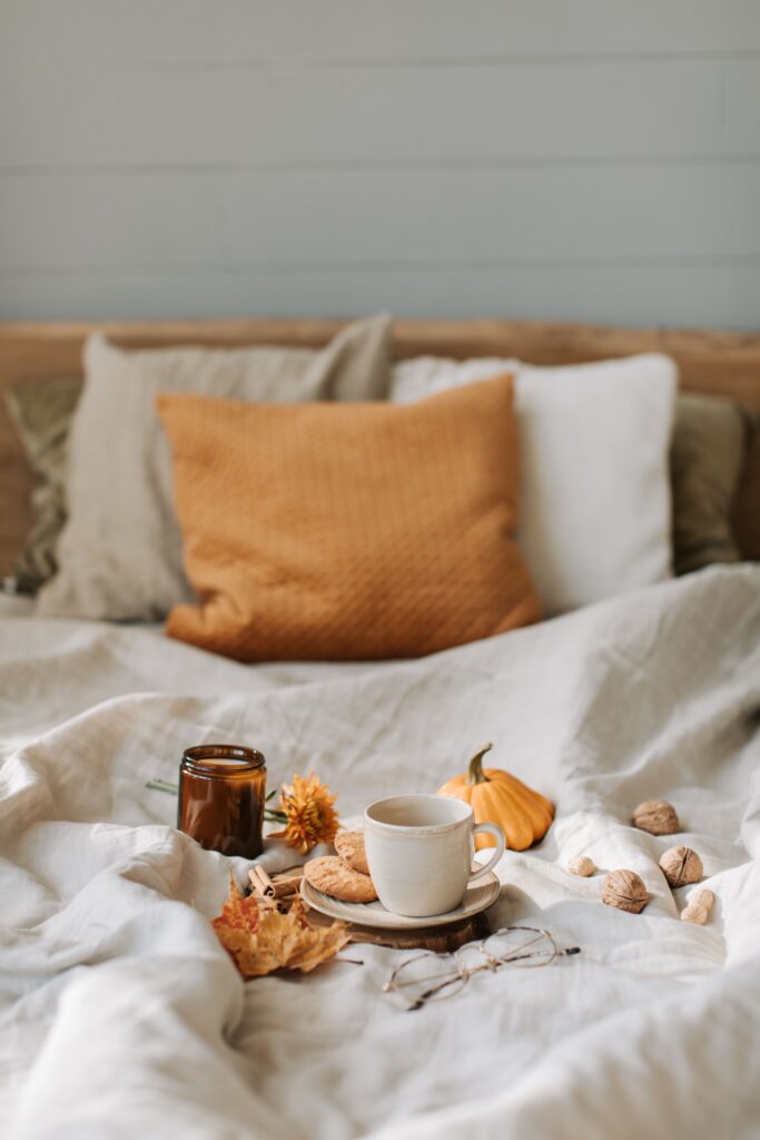 orange and beige throw pillows with fall bedroom decor