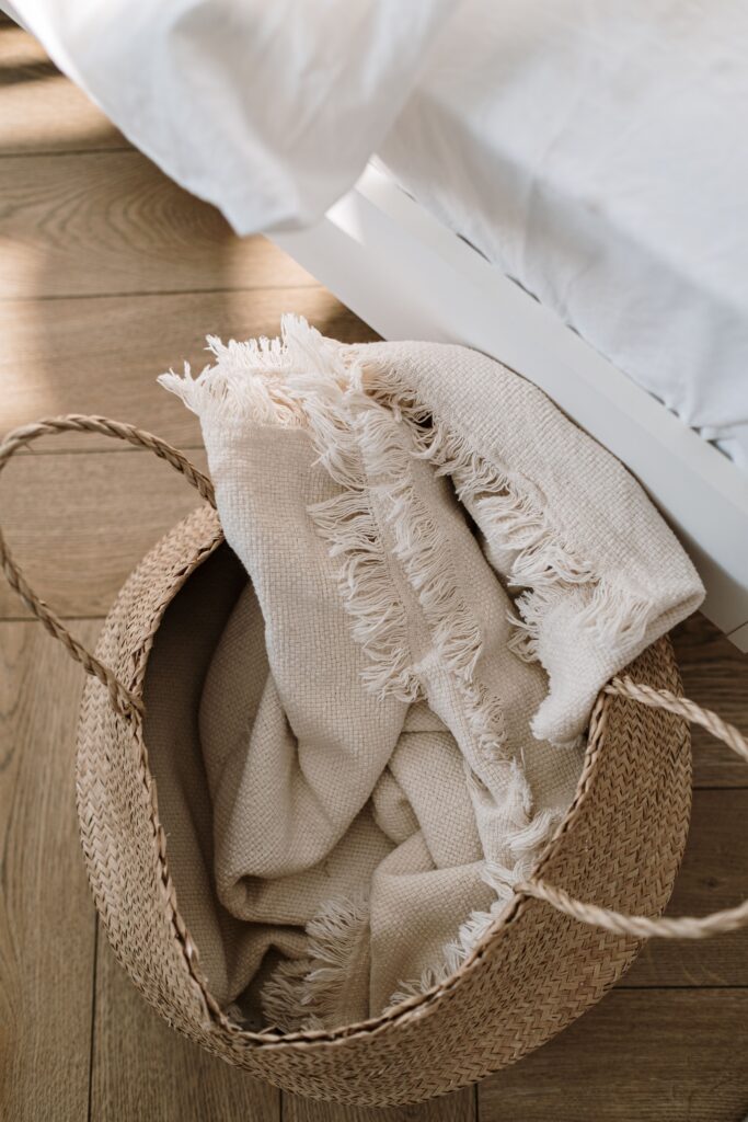 woven basket in bedroom with blanket