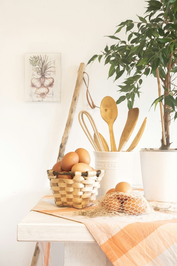 seasonal fall linen on kitchen table with utensils and a plant. Fall kitchen decor
