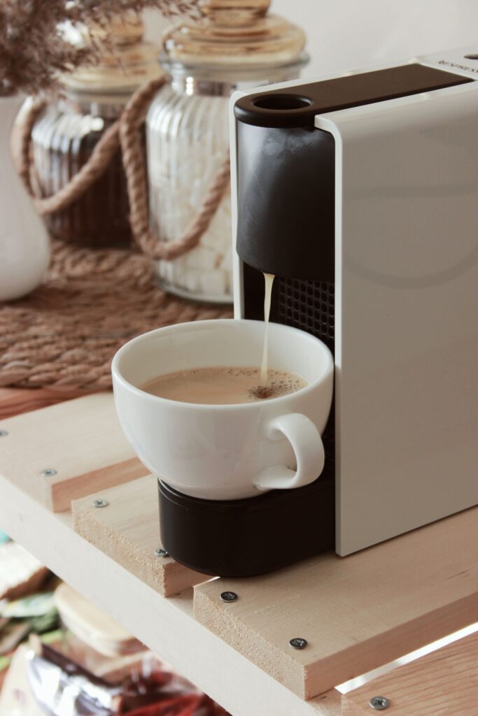 Fall kitchen decor with a coffee maker pouring coffee in a mug