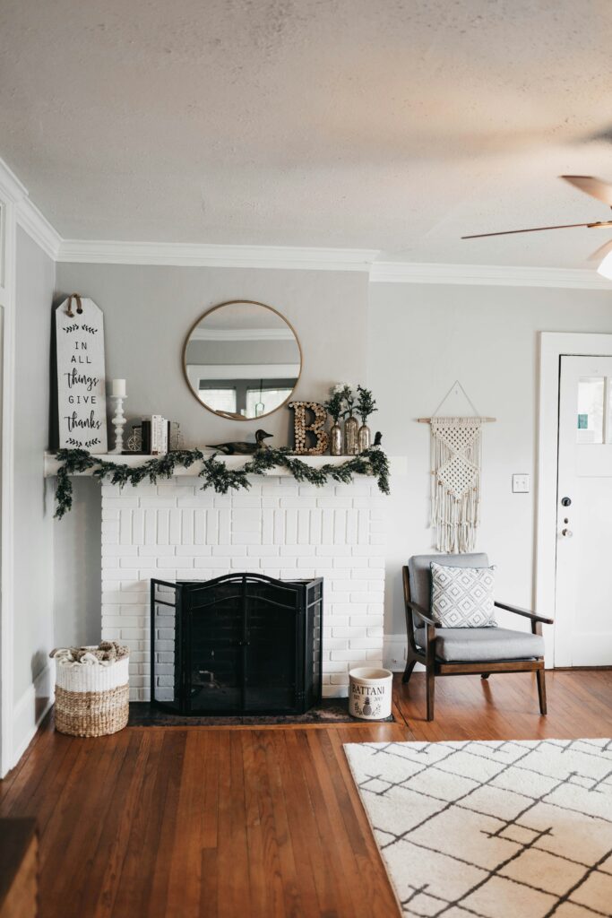 Neutral white fall decorated living room with circle mirror