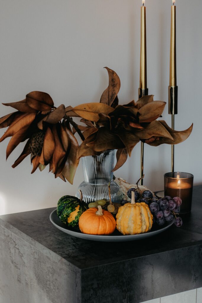 fall countertop decor with small pumpkins and candles to create a fall kitchen decor centerpiece
