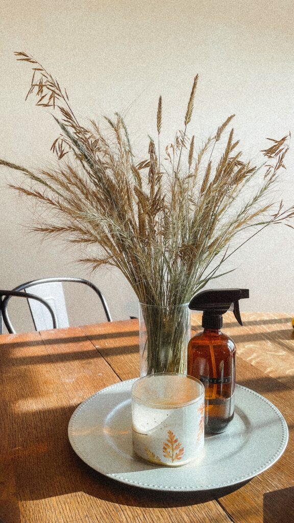 neutral fall kitchen decor, with wheat on the table and a small fall candle
