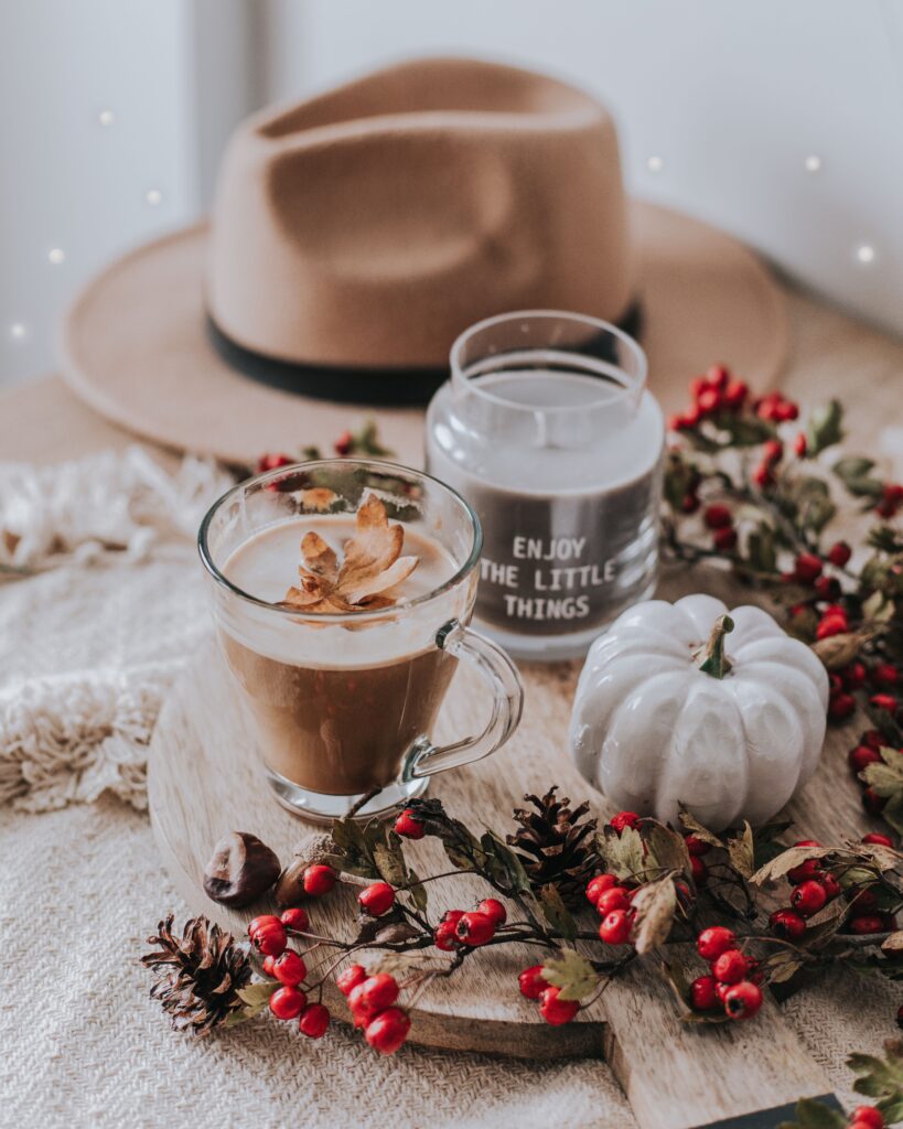 Fall Kitchen Decor on table with a beige hat and a small white pumpkin, a coffee cup also on the table