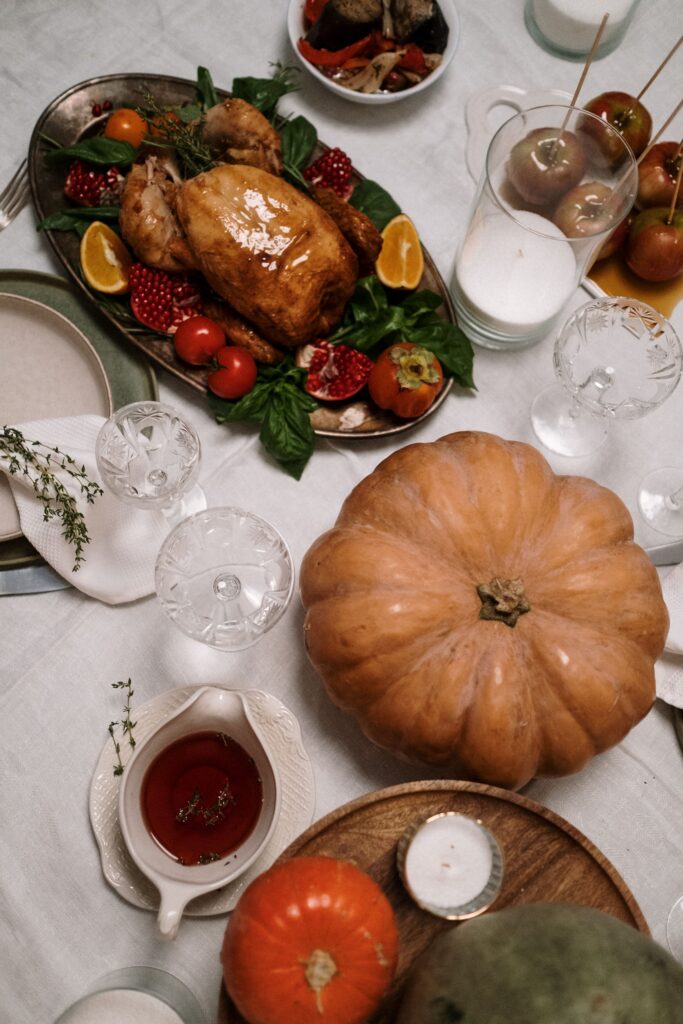 thanksgiving table dinner with a turkey and a pumpkin on the table